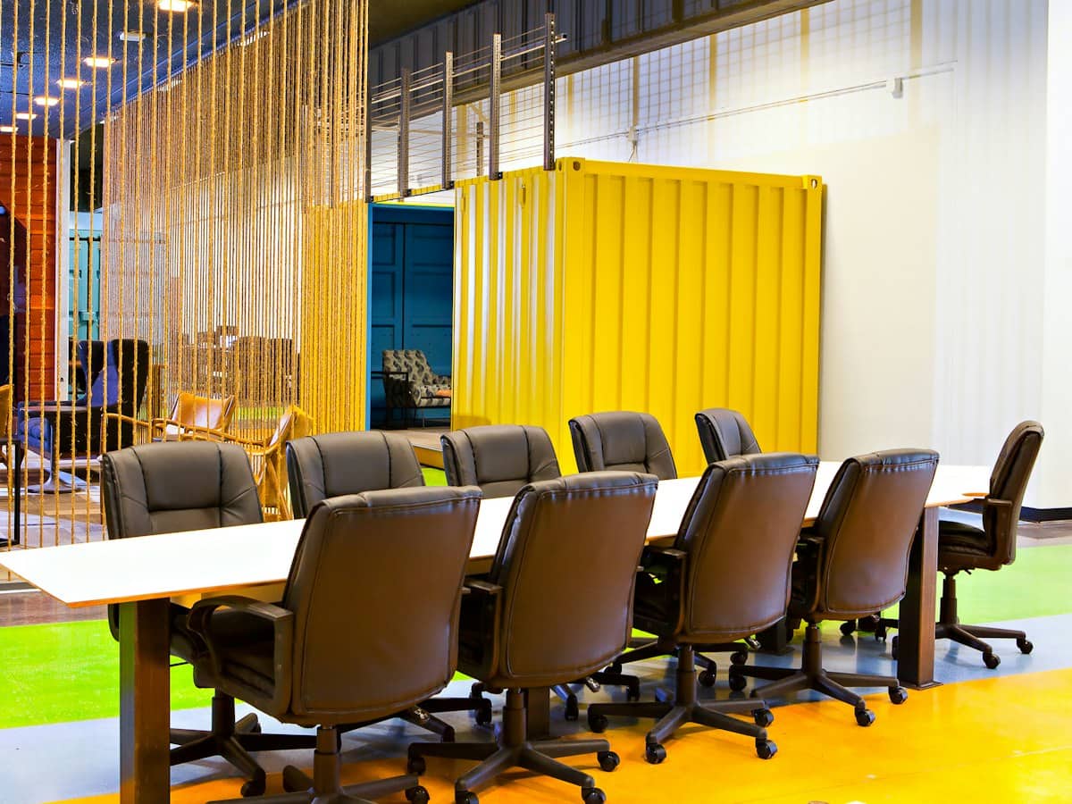 A long negotiating table lined with empty chairs
